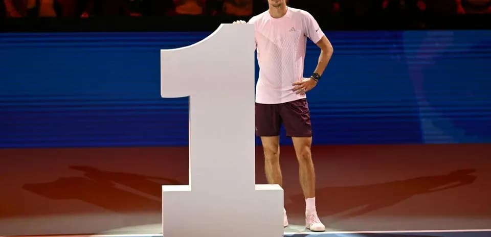 Player celebrating next to large number one sign