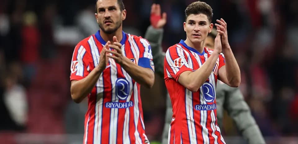 Two players applauding fans after match