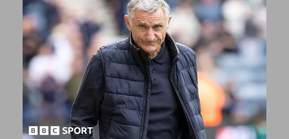 Manager walking on the pitch during a match