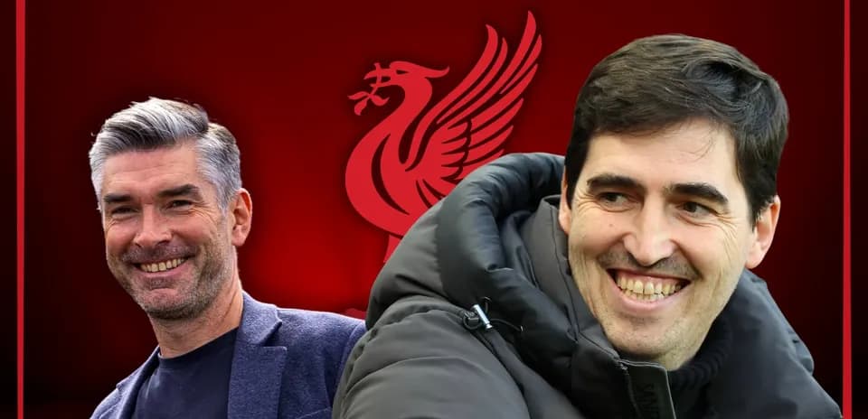 Two coaches smiling with Liverpool logo background