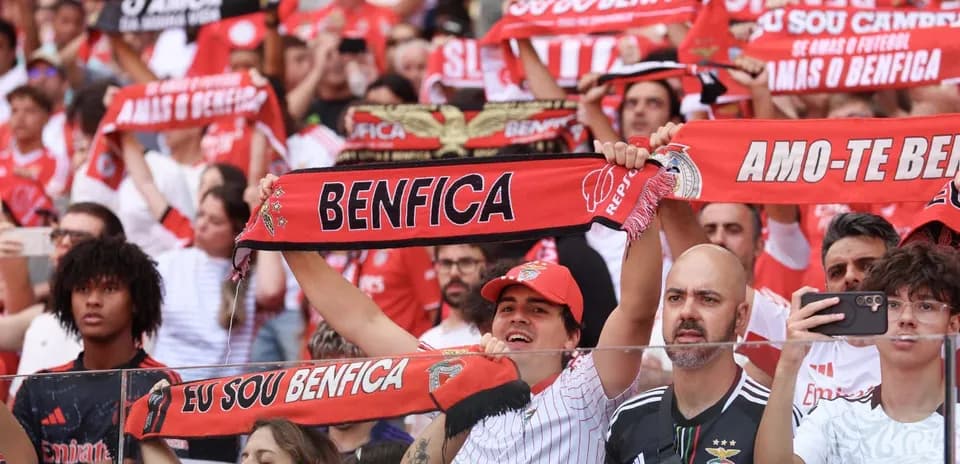 Benfica fans cheering with scarves in stadium