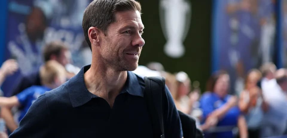 Man with short hair smiling in a crowd