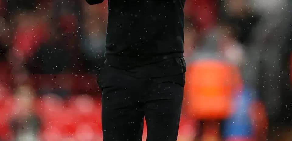 Manager clapping on the sideline during match