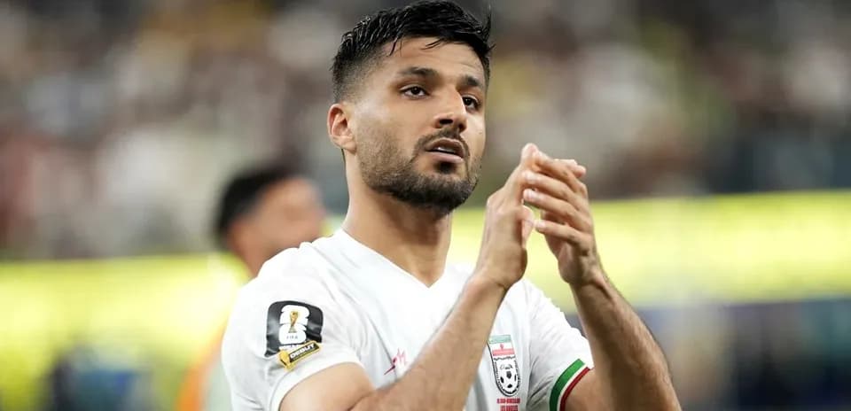 Player applauding fans during a match