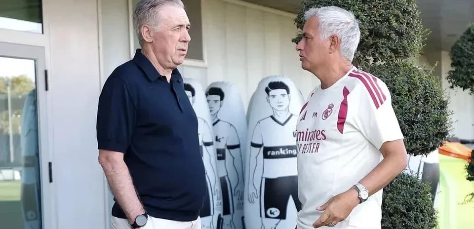 Two coaches conversing outside training facility