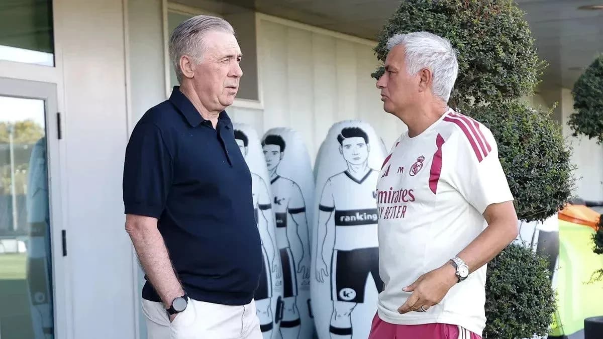 Two coaches conversing outside training facility