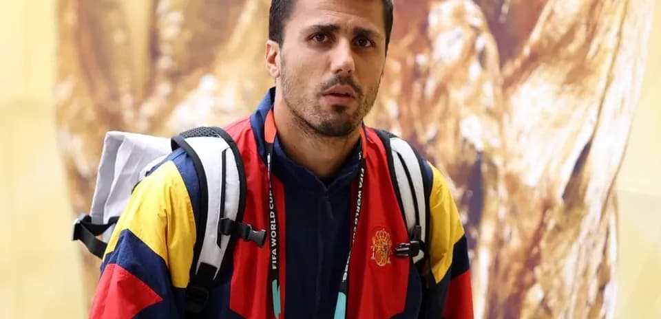 Athlete wearing Spain team jacket with backpack