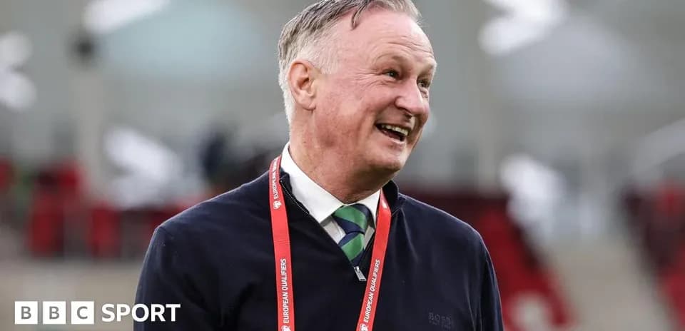 Manager smiling during pre-match event at stadium
