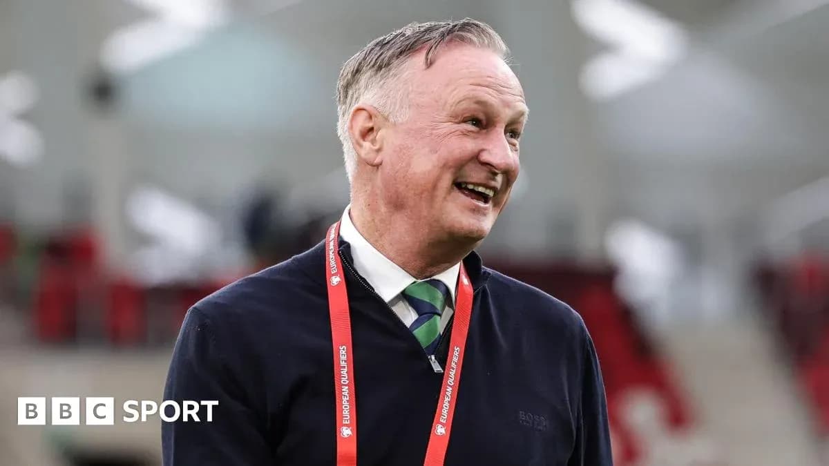 Manager smiling during pre-match event at stadium
