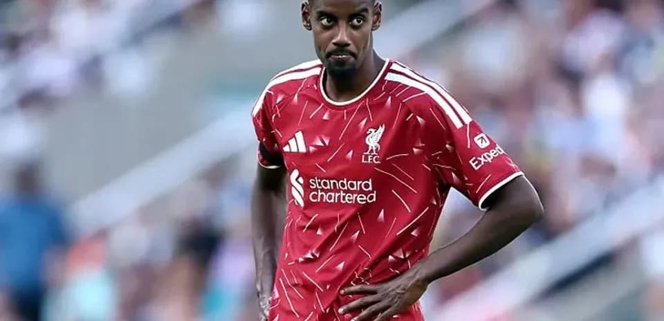 Player in Liverpool kit during match on field