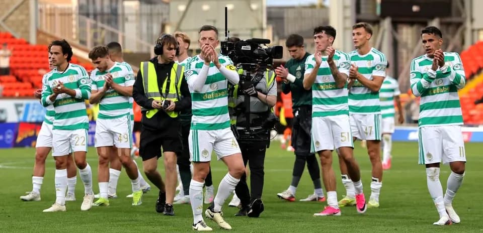 Celtic players applauding fans after match