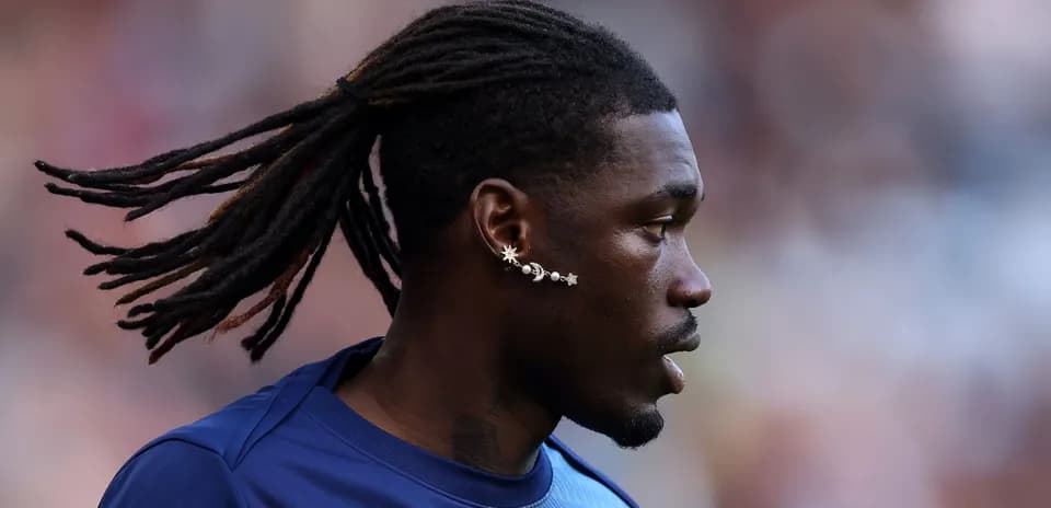 Player with long hair and unique earrings during match