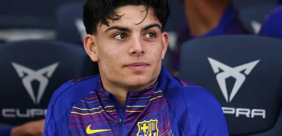 Barcelona player seated on the bench during match