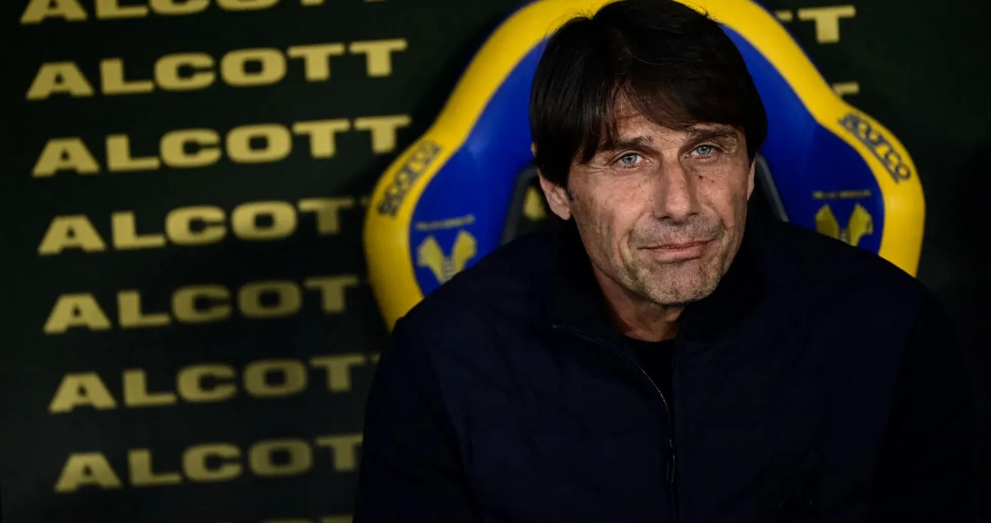 Coach seated on bench during a match