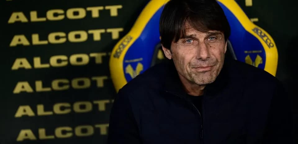 Coach seated on bench during a match