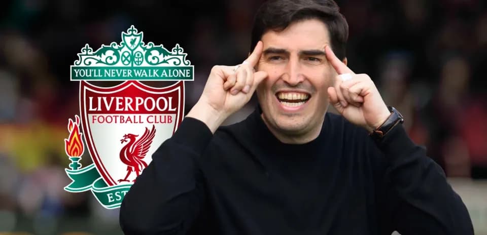 Coach gesturing enthusiastically near Liverpool FC logo