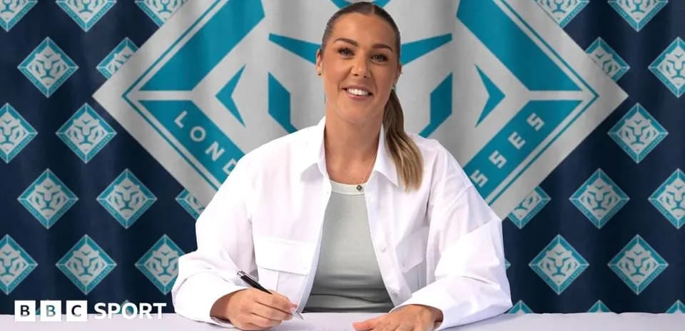Player signing contract at press conference table