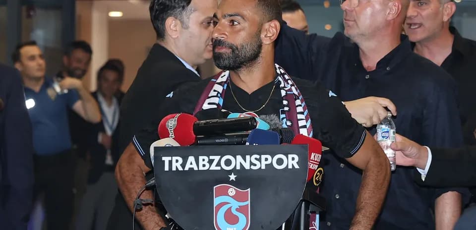 Player at press conference with Trabzonspor logo
