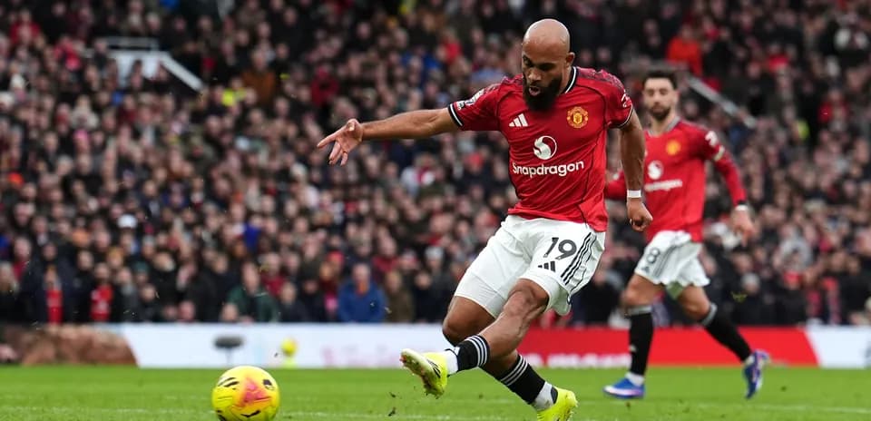 Player taking a shot during Manchester derby