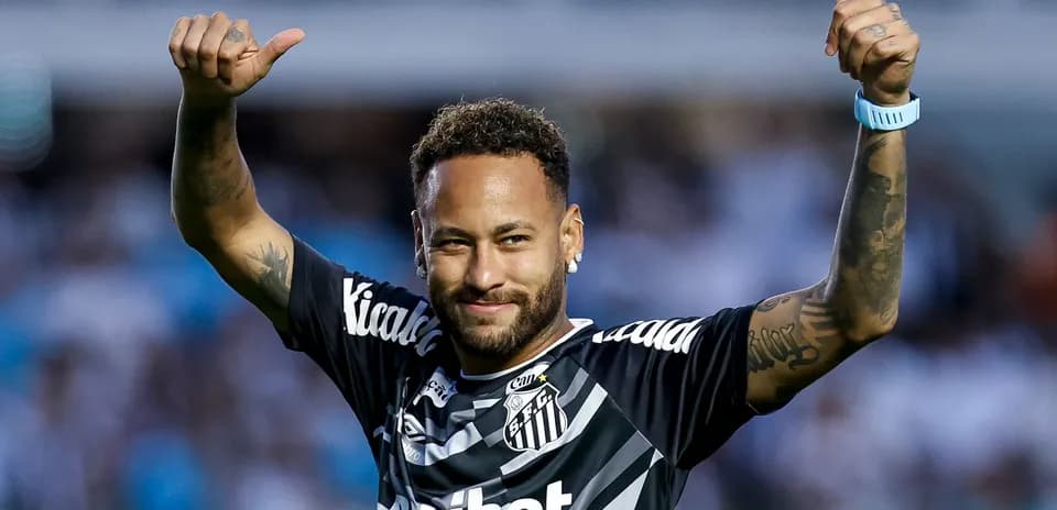 Player celebrating with thumbs up in Santos jersey
