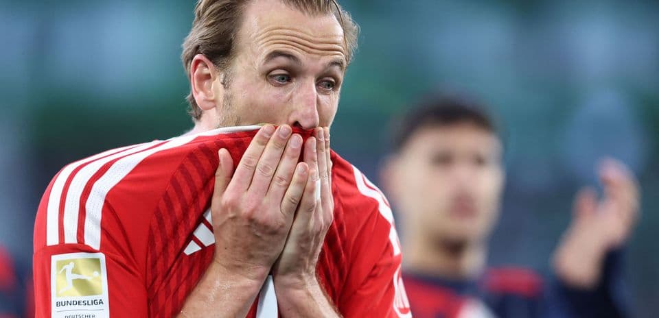Player holding shirt to face after match