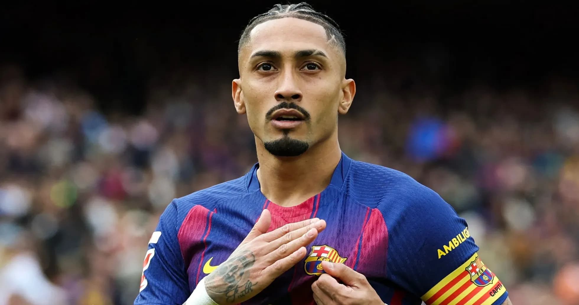 Player touching Barcelona badge on jersey