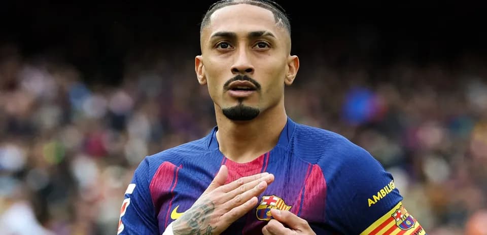 Player touching Barcelona badge on jersey