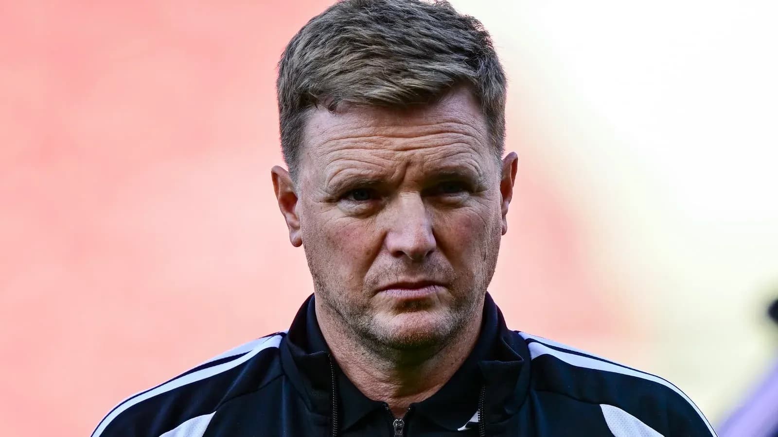 Coach in black tracksuit during pre-match preparations