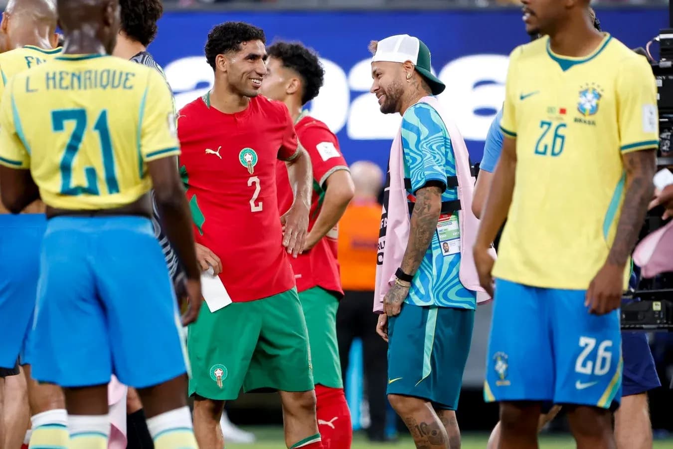 Players from Morocco and Brazil interacting on field