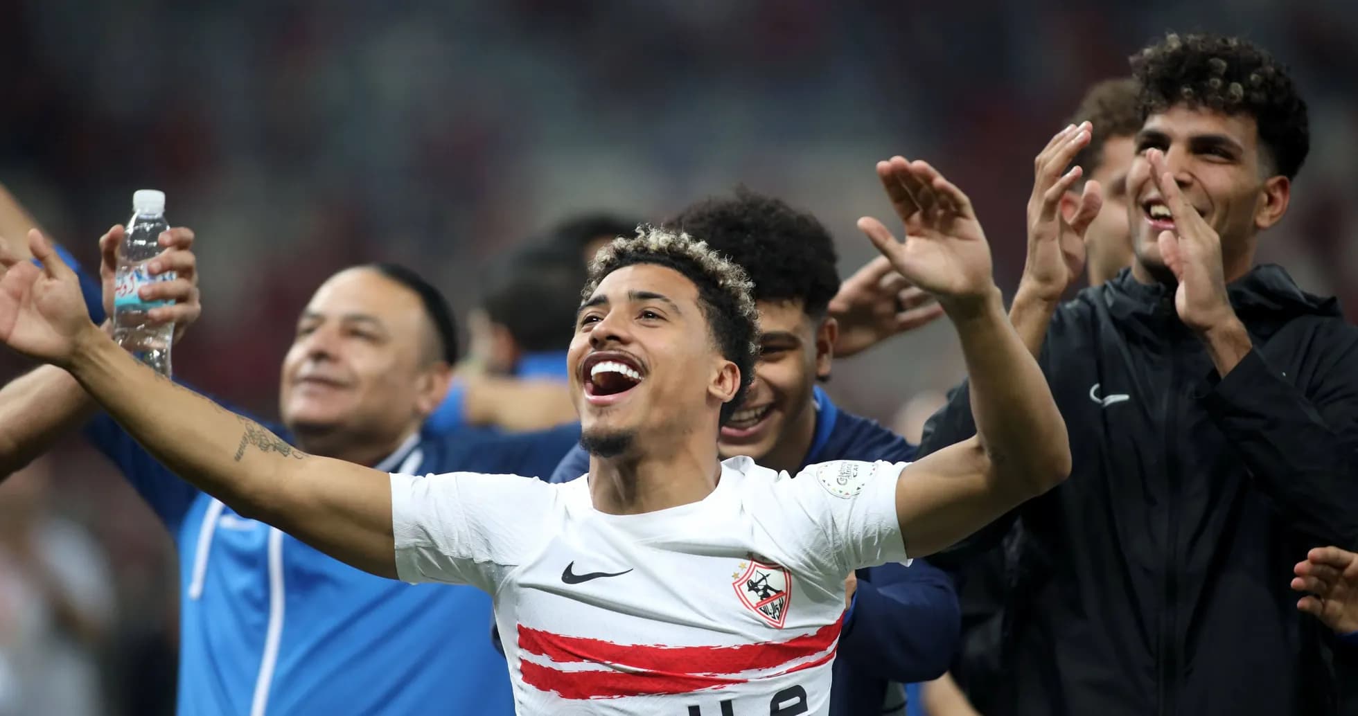 Players celebrating victory with arms raised