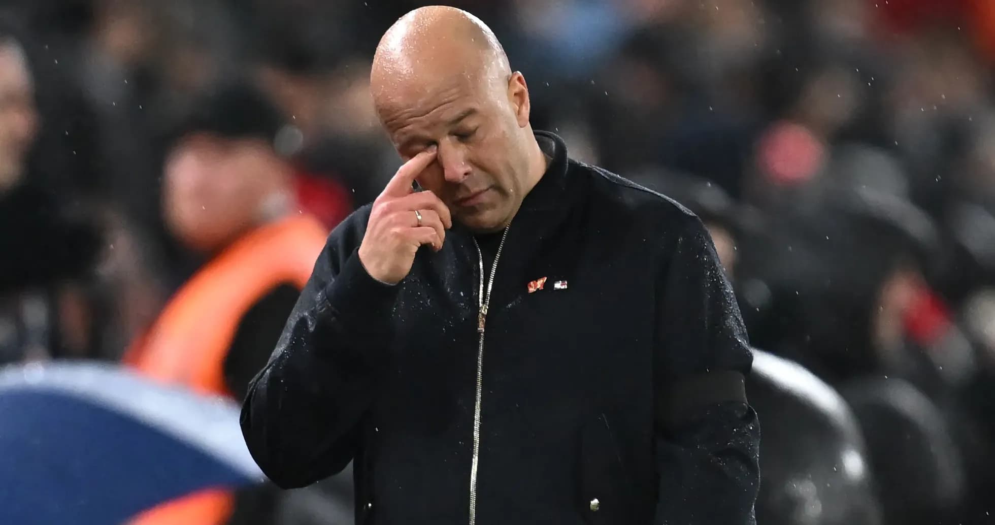 Coach wiping his forehead during a match