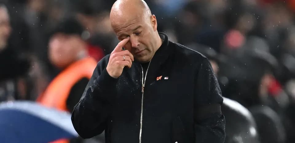 Coach wiping his forehead during a match