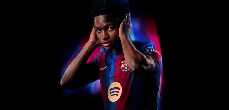 Player in Barcelona jersey posing with hands on head