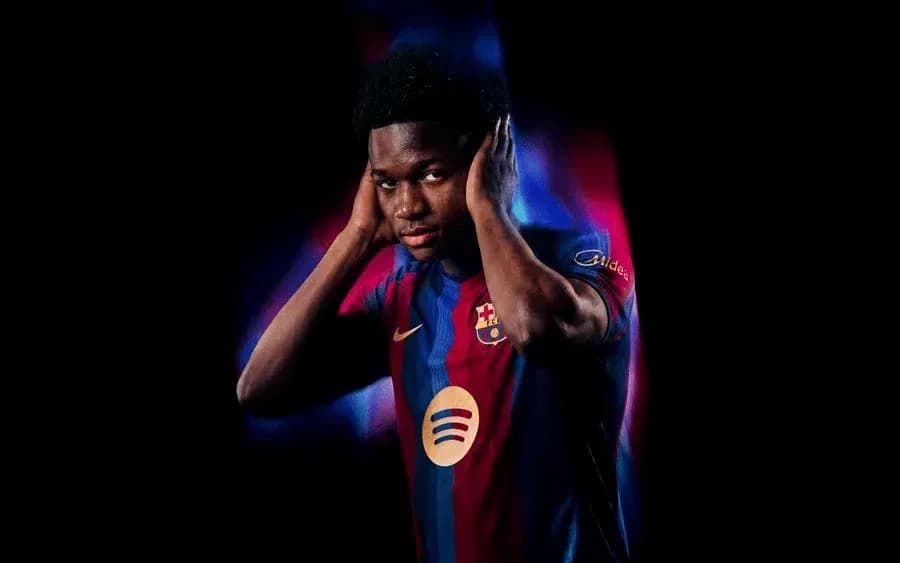 Player in Barcelona jersey posing with hands on head
