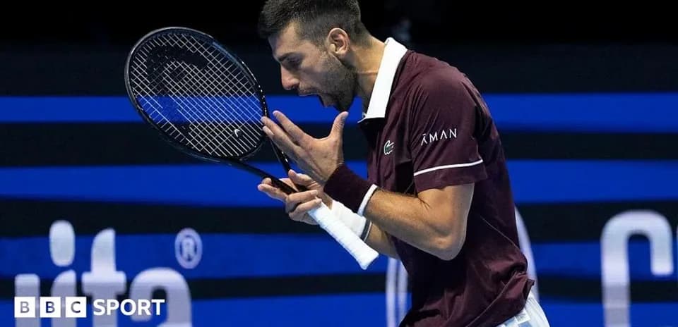 Tennis player celebrating a point with racket raised