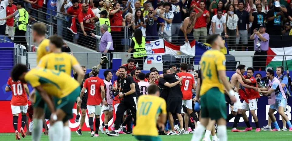 Players celebrating with fans after the match