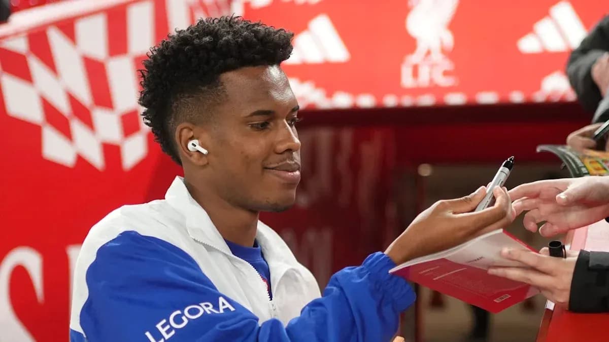 Player signing autographs for fans at event
