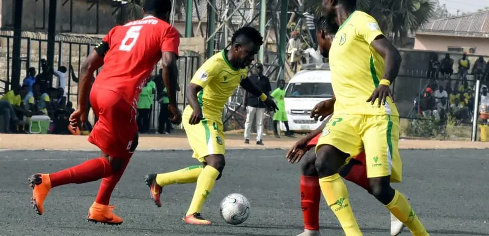 Players competing for the ball in NPFL match