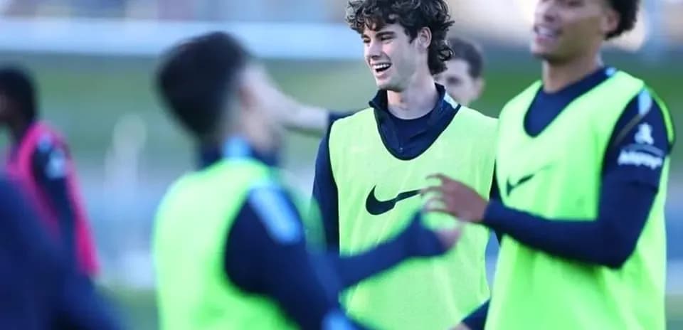 Players training and interacting on the pitch