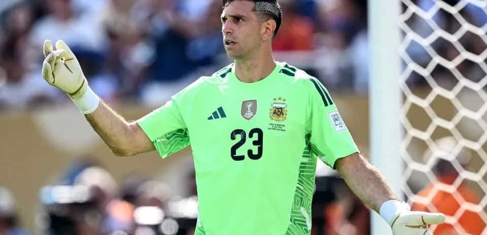 Goalkeeper in green uniform gesturing during match