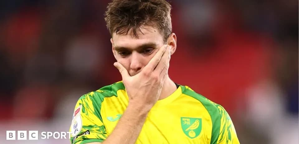 Player in Norwich City kit showing disappointment