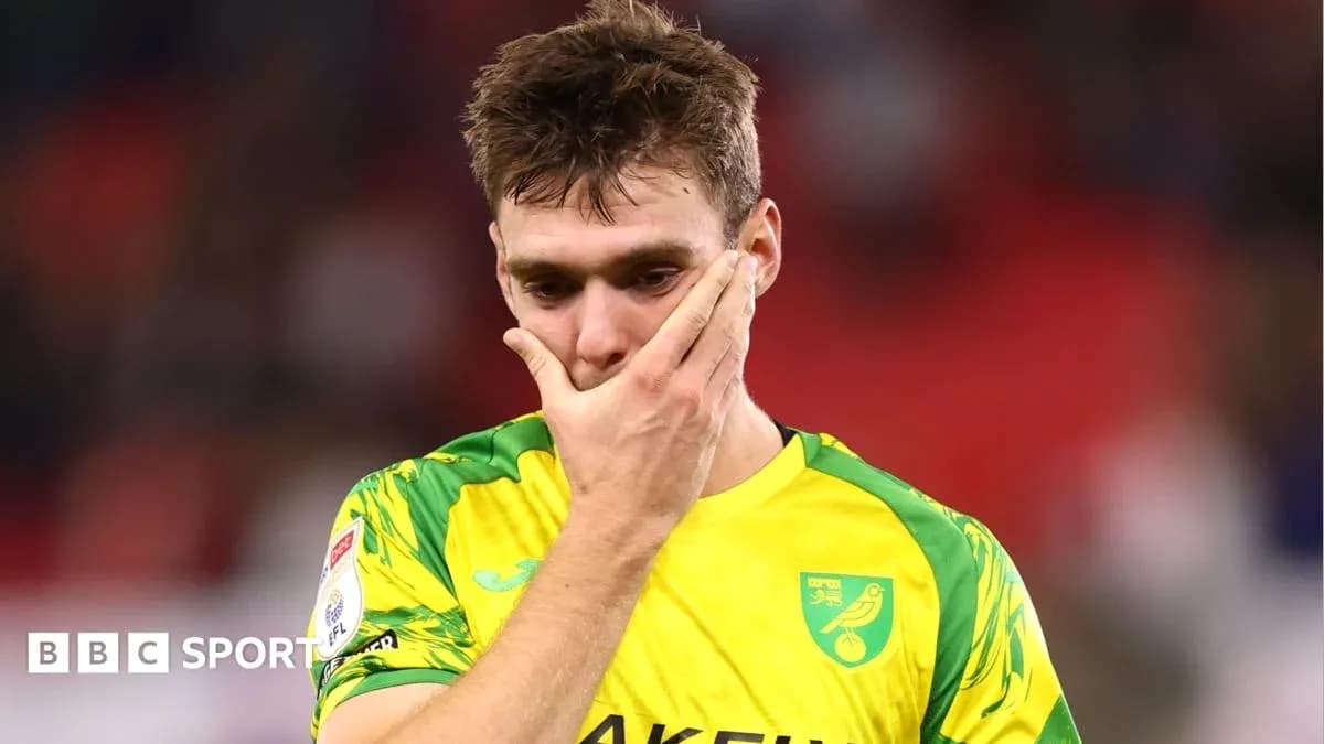 Player in Norwich City kit showing disappointment