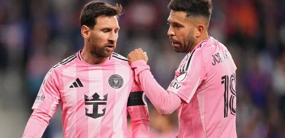 Two players discussing during a match in pink uniforms