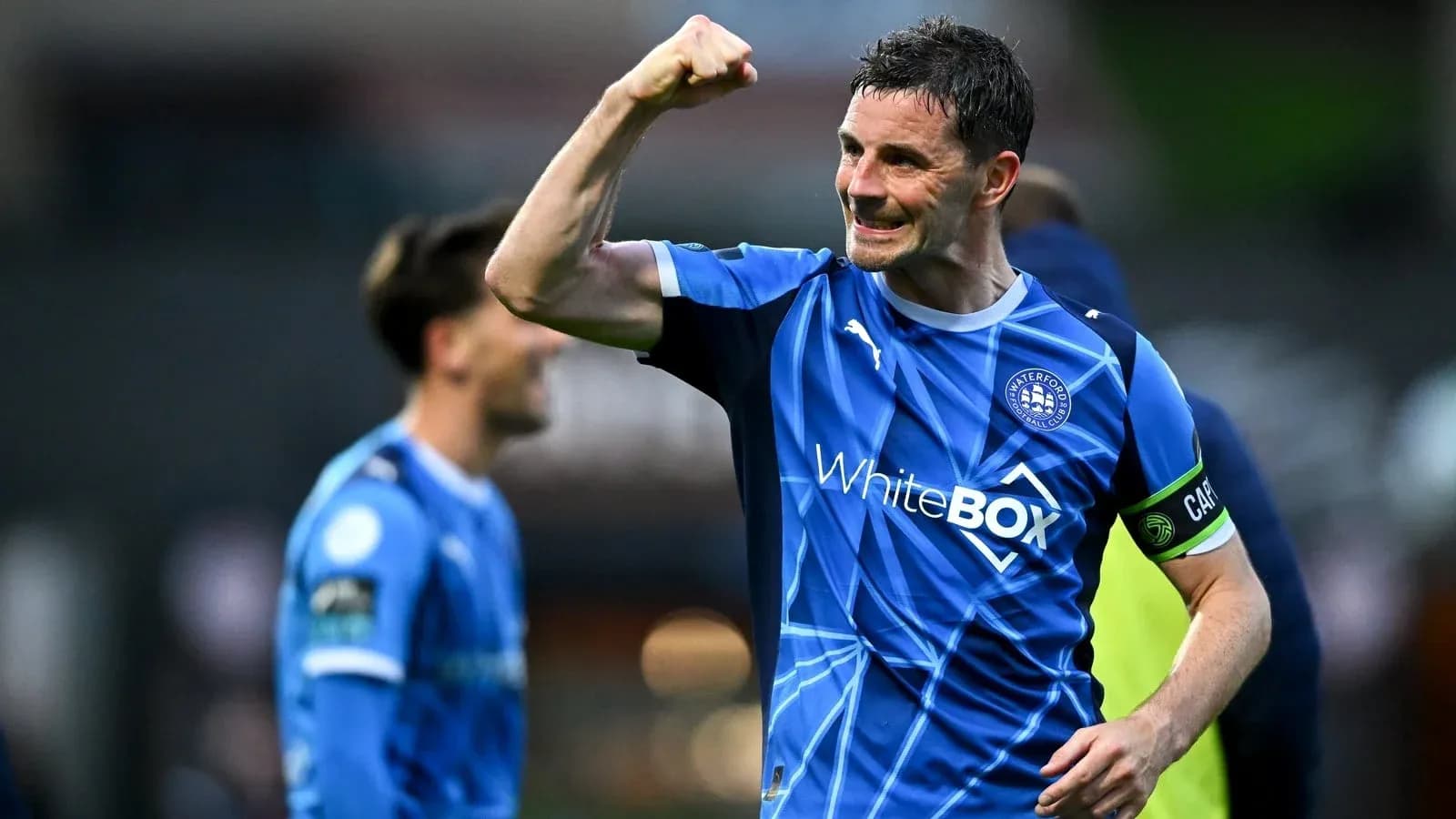 Player celebrating victory in Waterford FC jersey