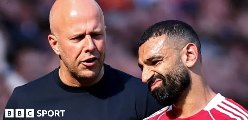 Two men conversing on the pitch during match
