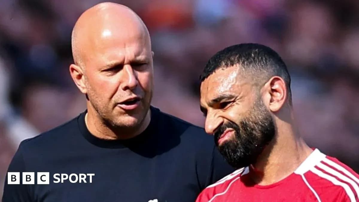 Two men conversing on the pitch during match