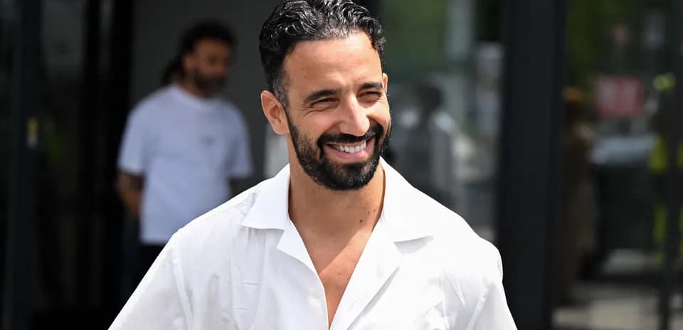 Man in white shirt smiling outdoors