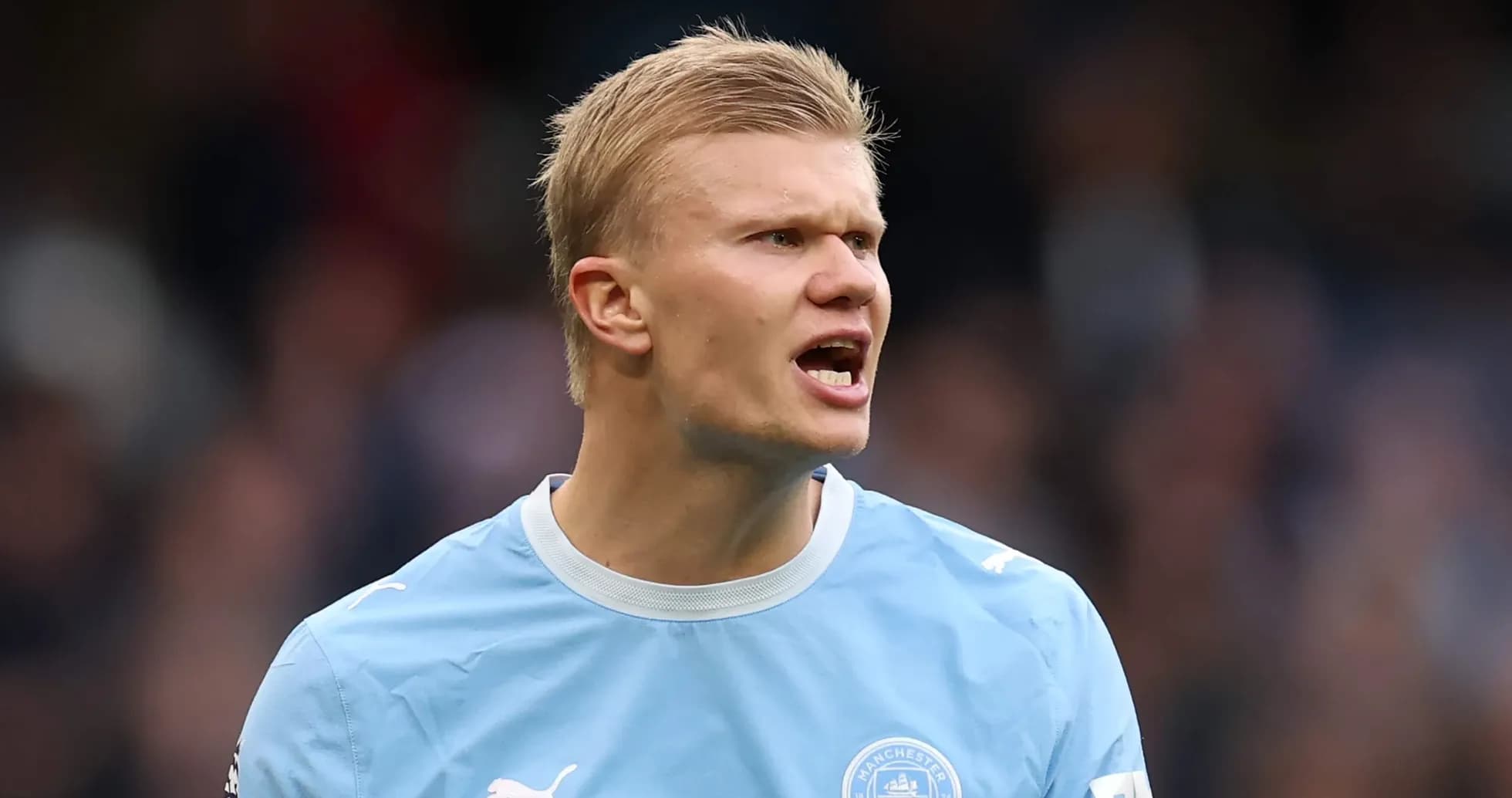 Player in Manchester City kit shouting during match