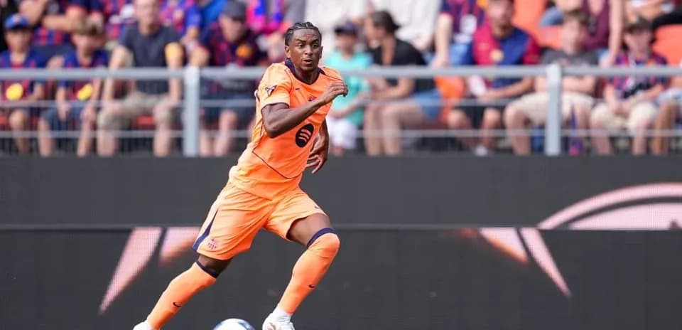 Player in orange kit sprinting on the pitch
