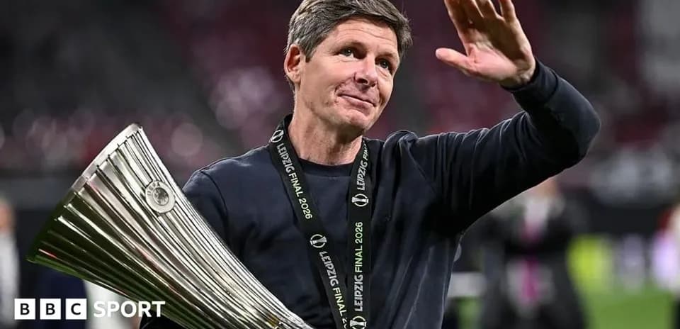 Coach holding trophy and waving after victory